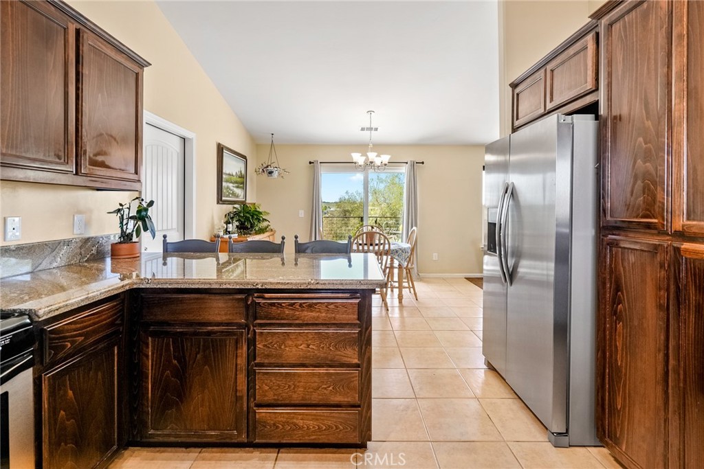 5950 Forked Horn Place Paso Robles, CA 93446 - Photo 7 of 31 a kitchen with stainless steel appliances granite countertop a refrigerator and a sink