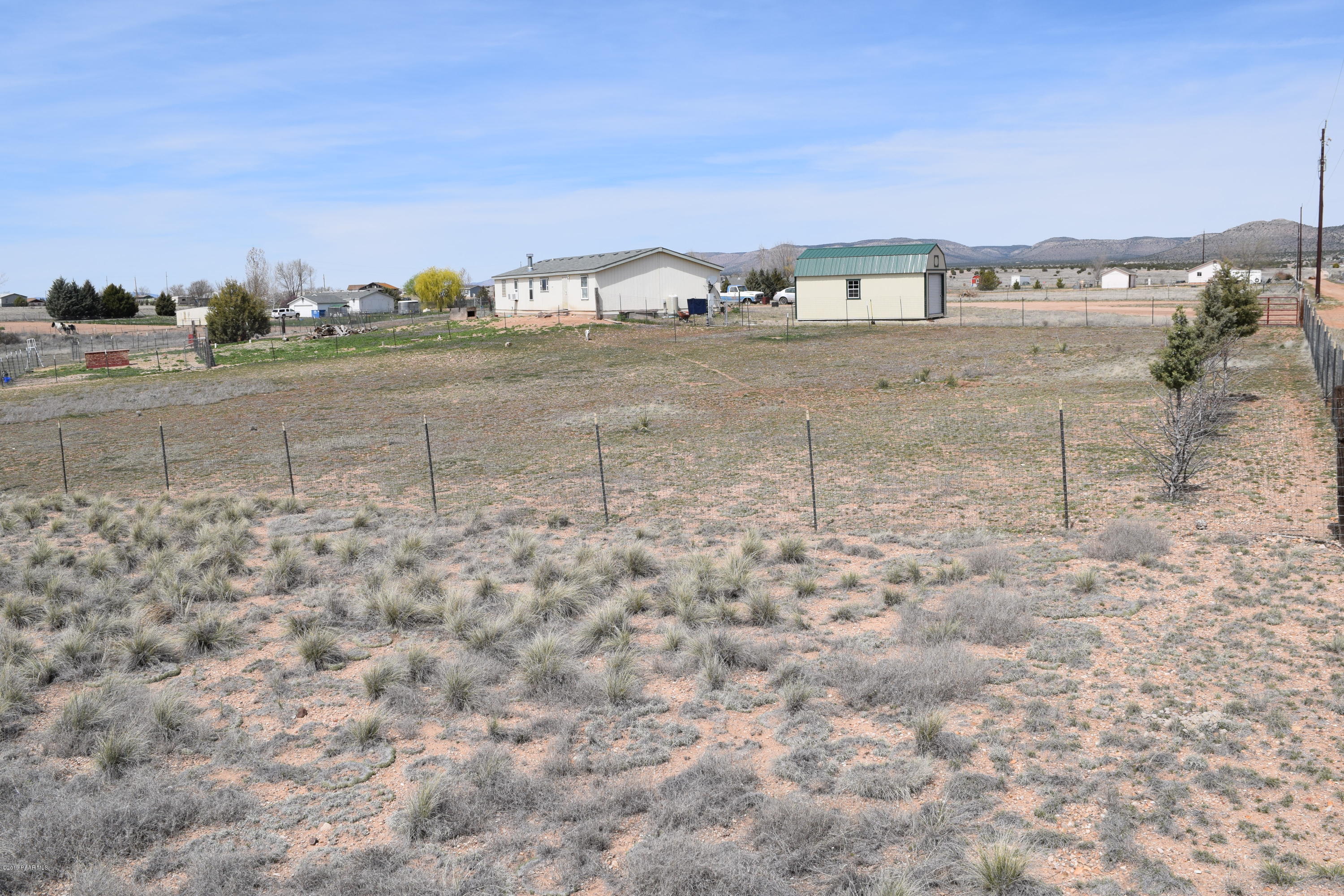 25300 North Patricia Road Paulden, AZ 86334 - Photo 3 of 8 a view of a dry yard with wooden fence