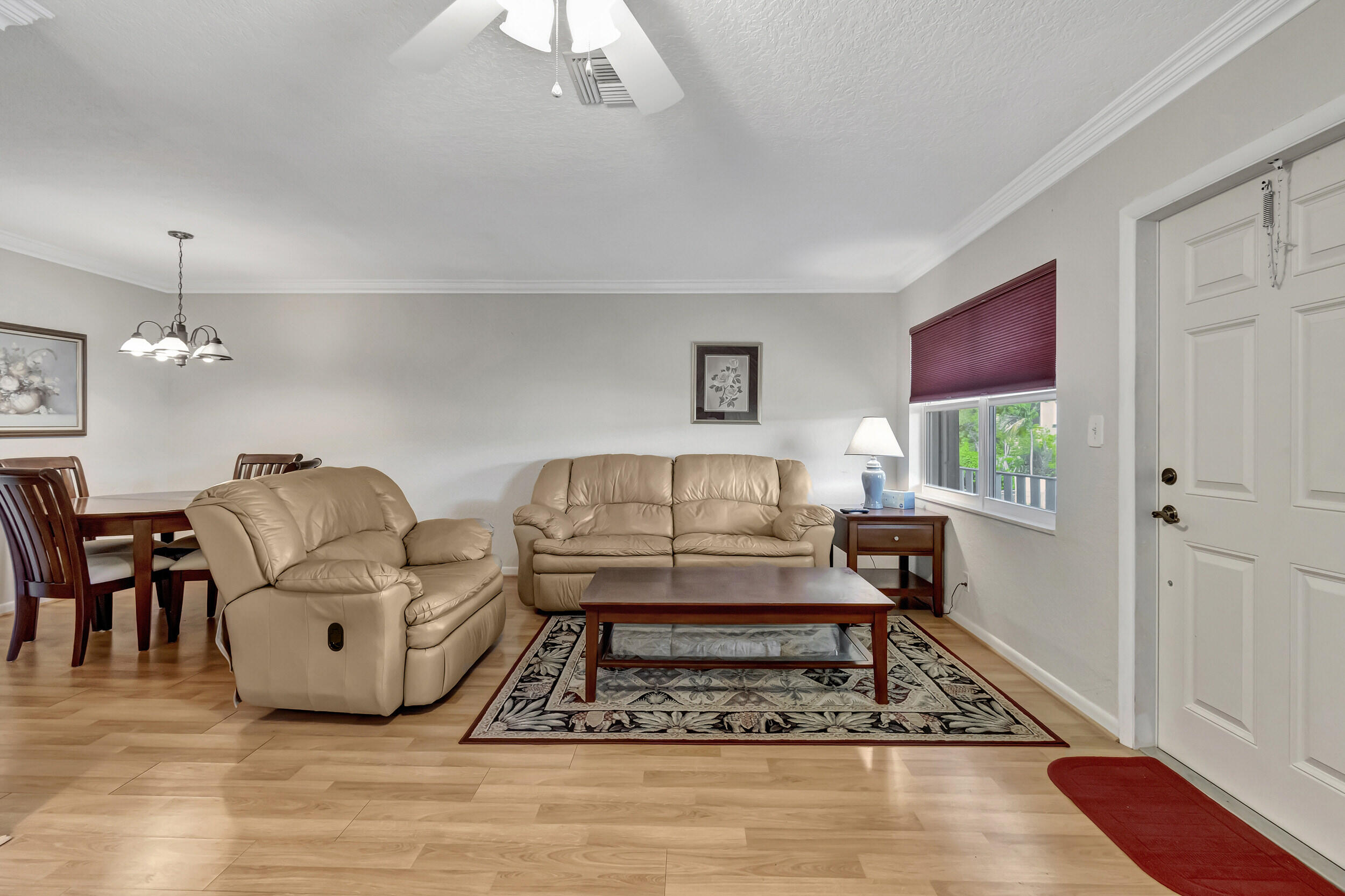 5540 North Ocean Boulevard, Unit 204 Ocean Ridge, FL 33435 - Photo 11 of 52 a living room with furniture and a wooden floor