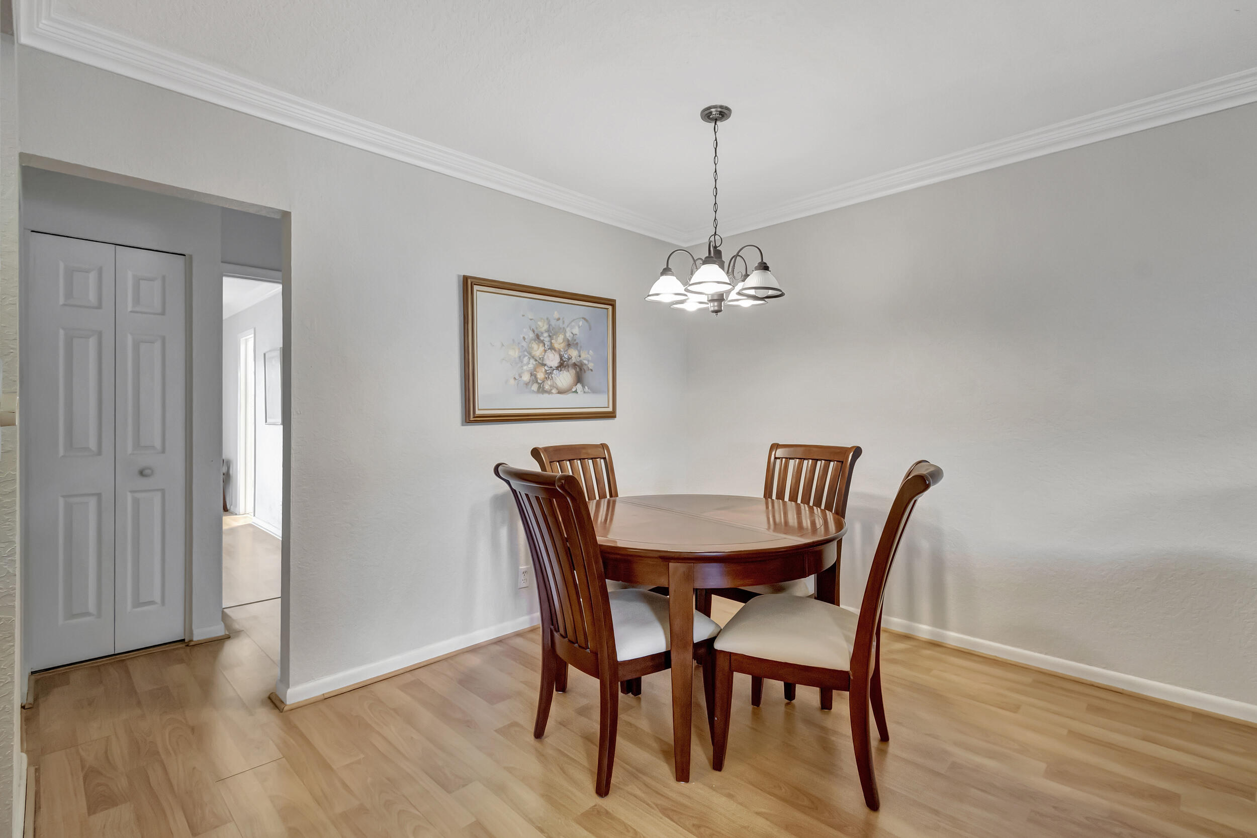 5540 North Ocean Boulevard, Unit 204 Ocean Ridge, FL 33435 - Photo 12 of 52 a view of a dining room with furniture wooden floor and chandelier