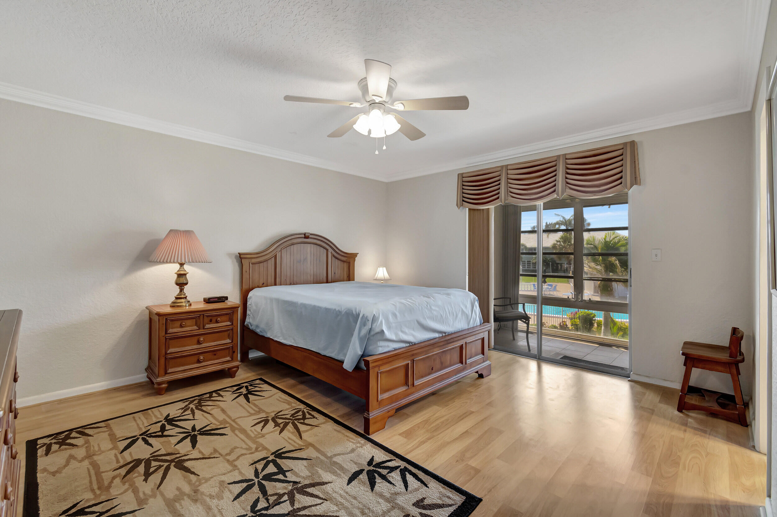 5540 North Ocean Boulevard, Unit 204 Ocean Ridge, FL 33435 - Photo 18 of 52 a bedroom with a bed and wooden floor