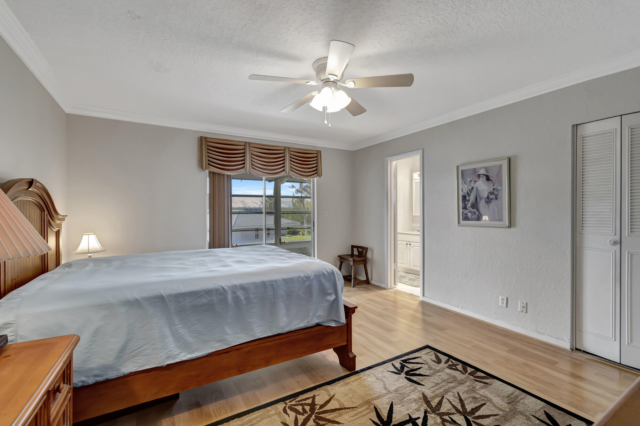 5540 North Ocean Boulevard, Unit 204 Ocean Ridge, FL 33435 - Photo 19 of 52 a bedroom with a bed and a window