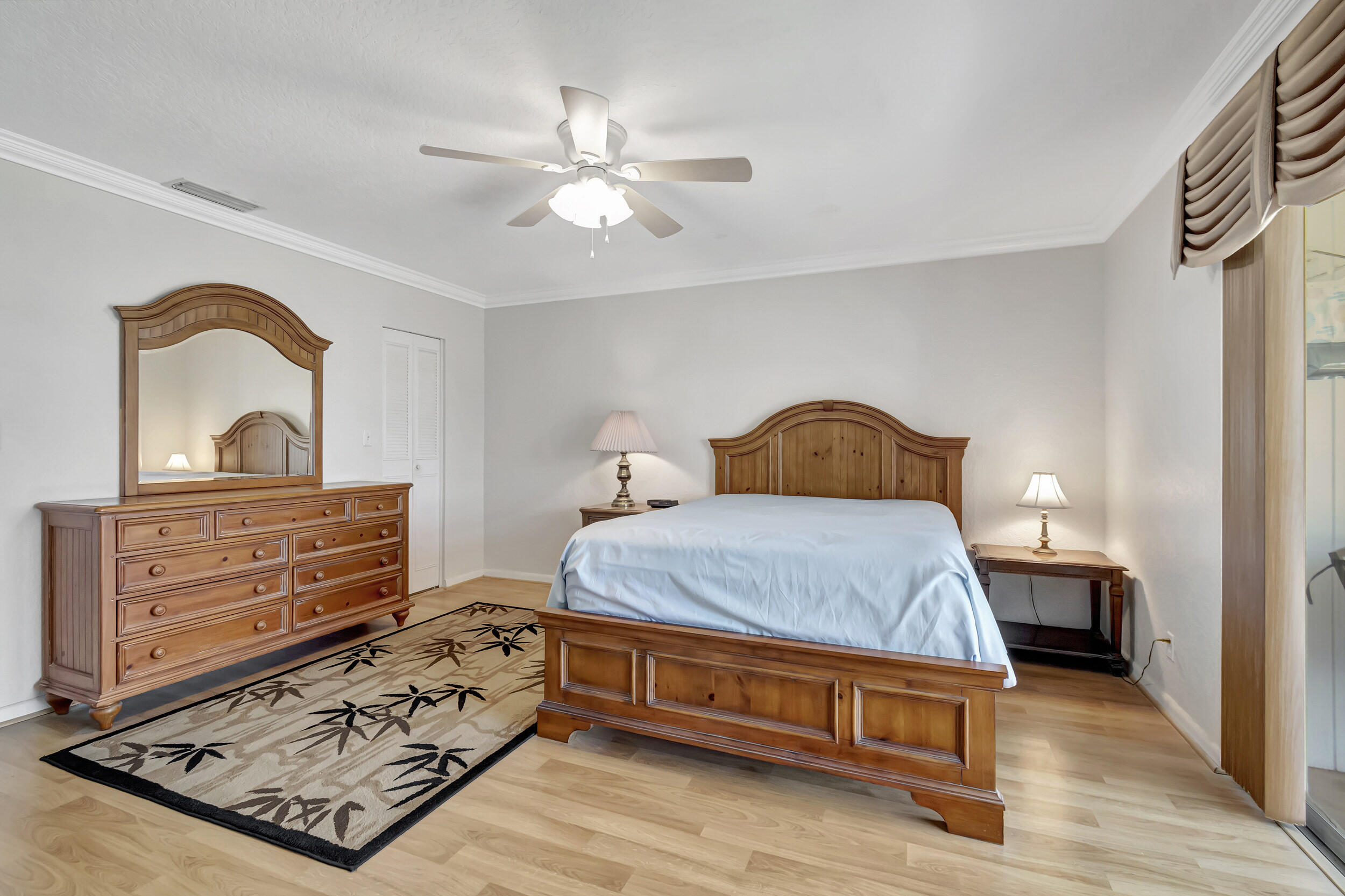 5540 North Ocean Boulevard, Unit 204 Ocean Ridge, FL 33435 - Photo 20 of 52 a bedroom with a bed and a dresser