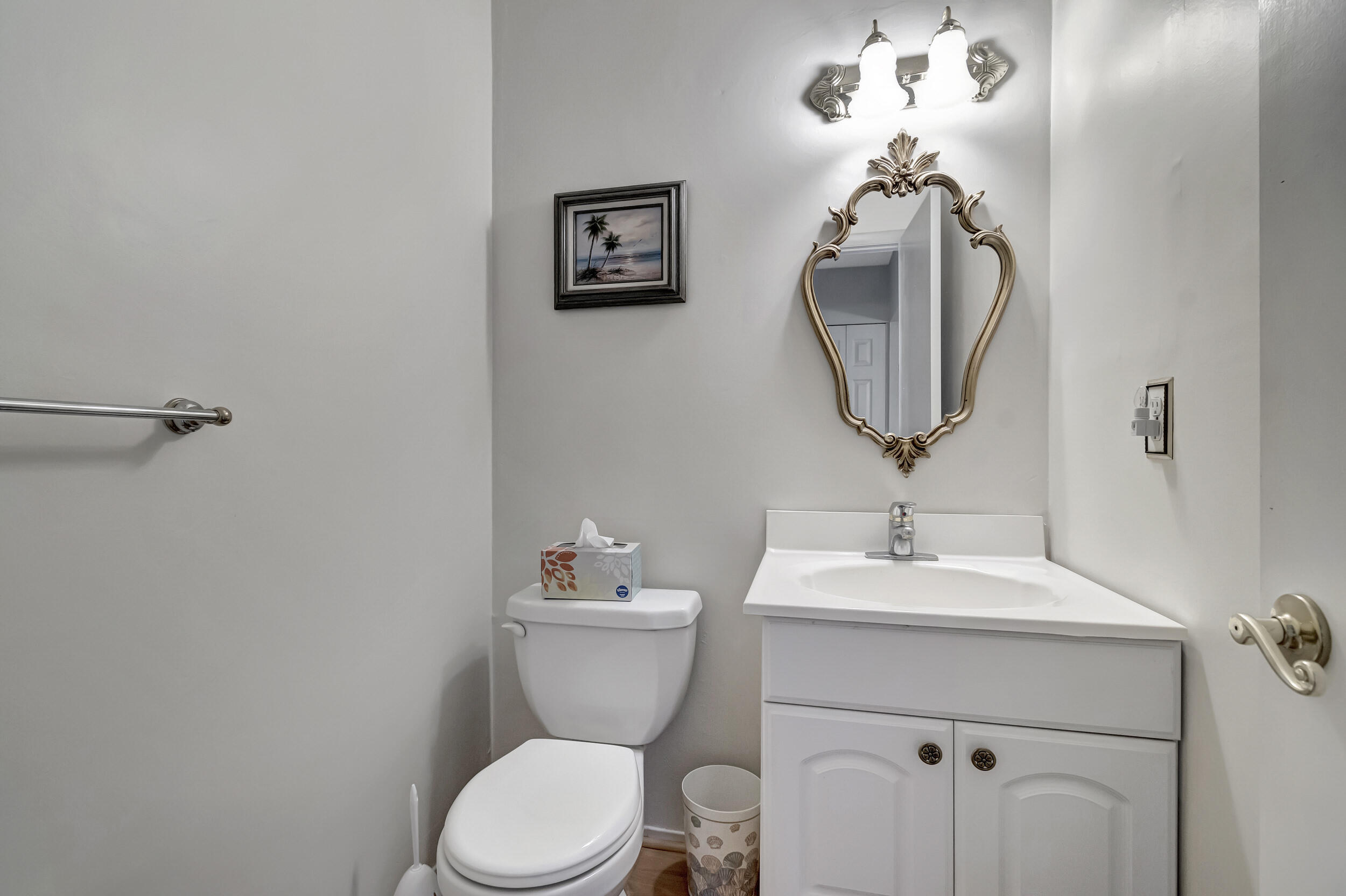 5540 North Ocean Boulevard, Unit 204 Ocean Ridge, FL 33435 - Photo 31 of 52 a bathroom with a toilet a sink and mirror