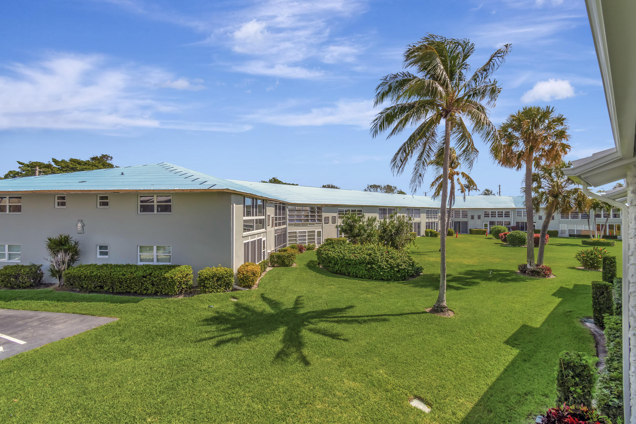 5540 North Ocean Boulevard, Unit 204 Ocean Ridge, FL 33435 - Photo 32 of 52 a view of a house with backyard and a tree