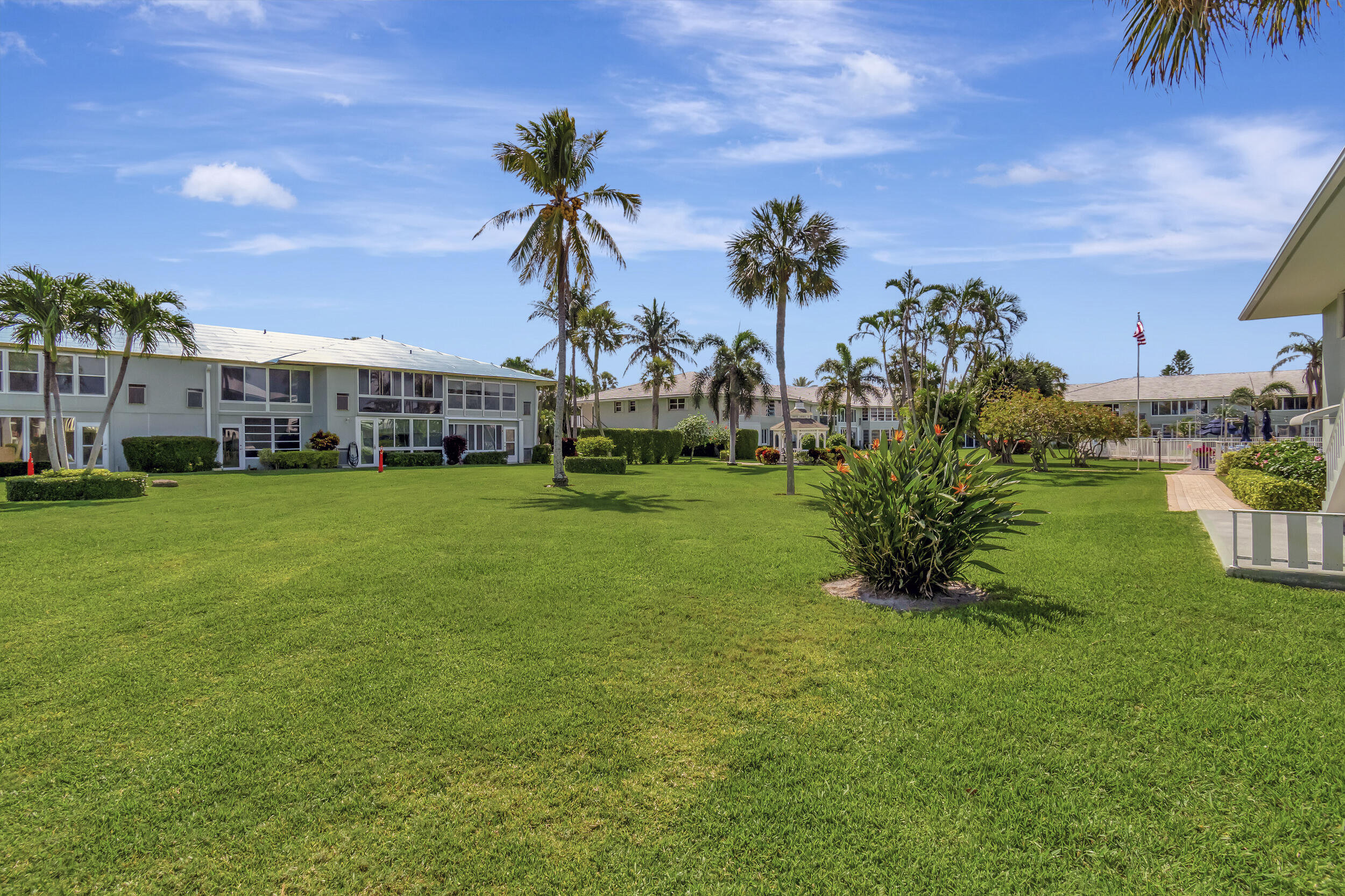 5540 North Ocean Boulevard, Unit 204 Ocean Ridge, FL 33435 - Photo 33 of 52 a view of a garden with a house in the background