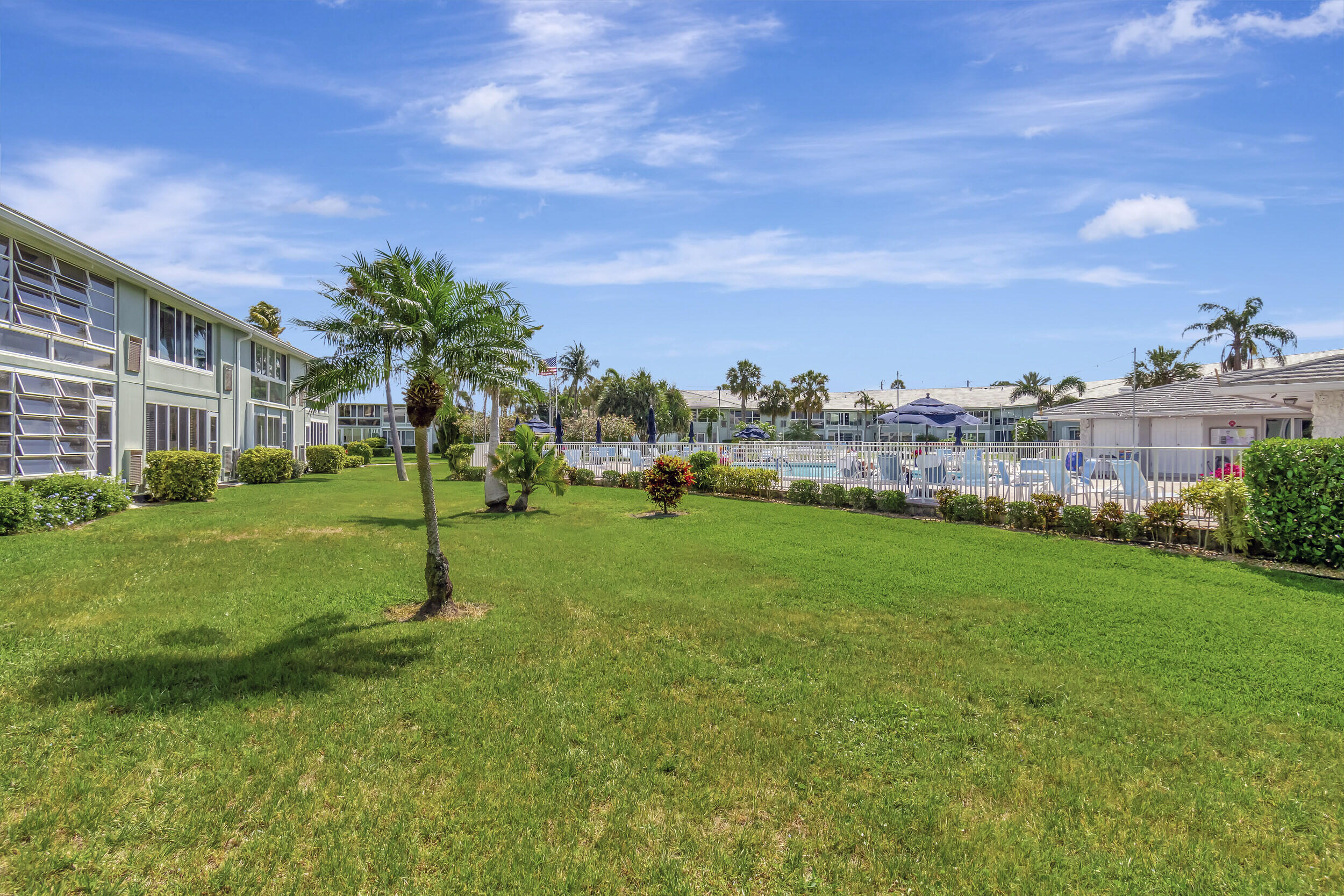 5540 North Ocean Boulevard, Unit 204 Ocean Ridge, FL 33435 - Photo 36 of 52 a view of a big yard with a house in the background