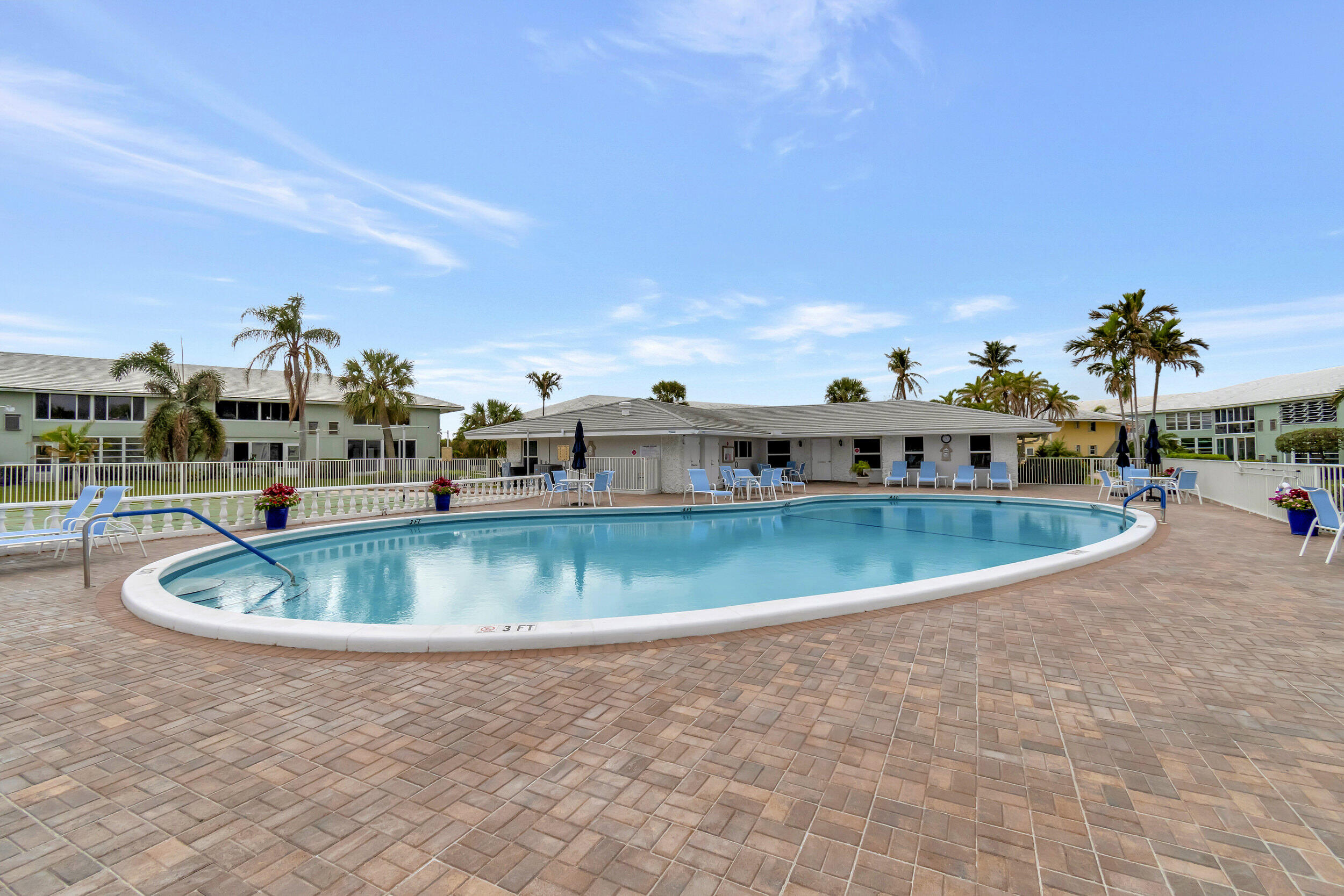 5540 North Ocean Boulevard, Unit 204 Ocean Ridge, FL 33435 - Photo 40 of 52 a view of a swimming pool with a yard
