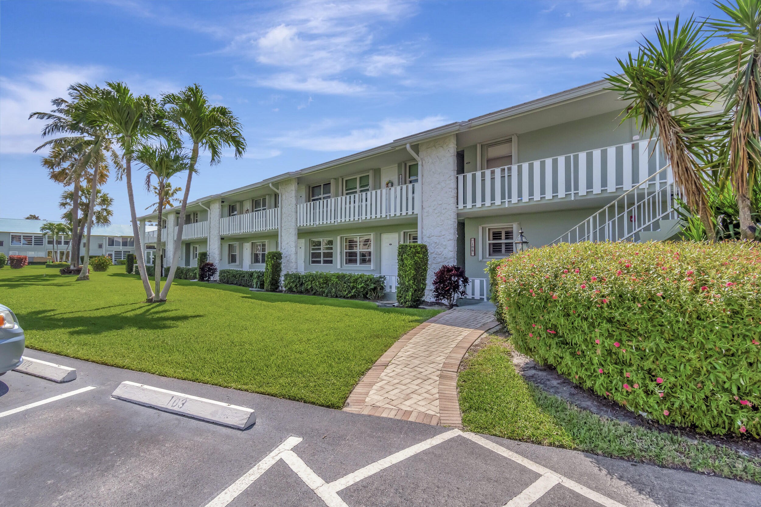 5540 North Ocean Boulevard, Unit 204 Ocean Ridge, FL 33435 - Photo 50 of 52 a view of a house with a yard and potted plants