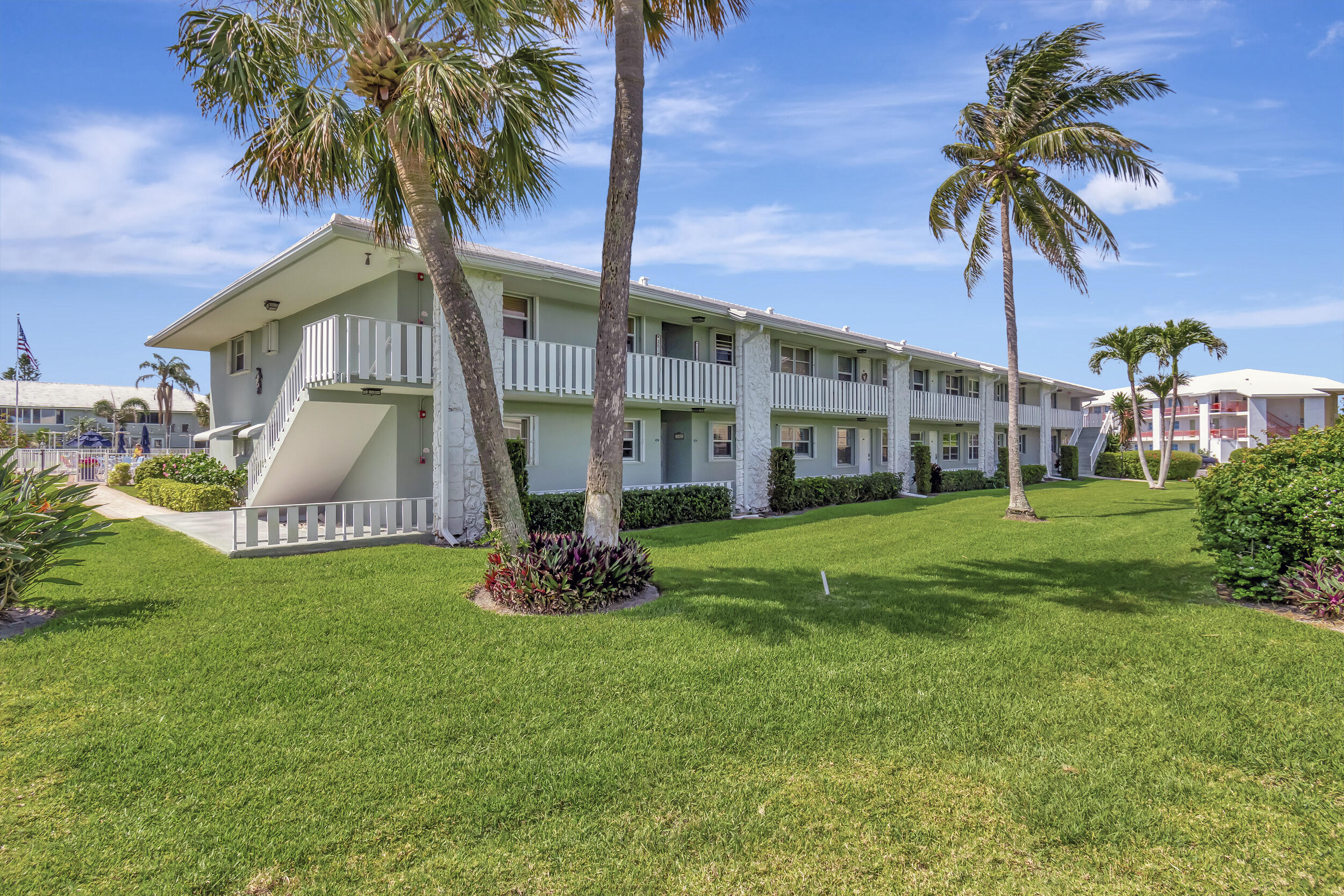 5540 North Ocean Boulevard, Unit 204 Ocean Ridge, FL 33435 - Photo 51 of 52 a front view of a house with garden