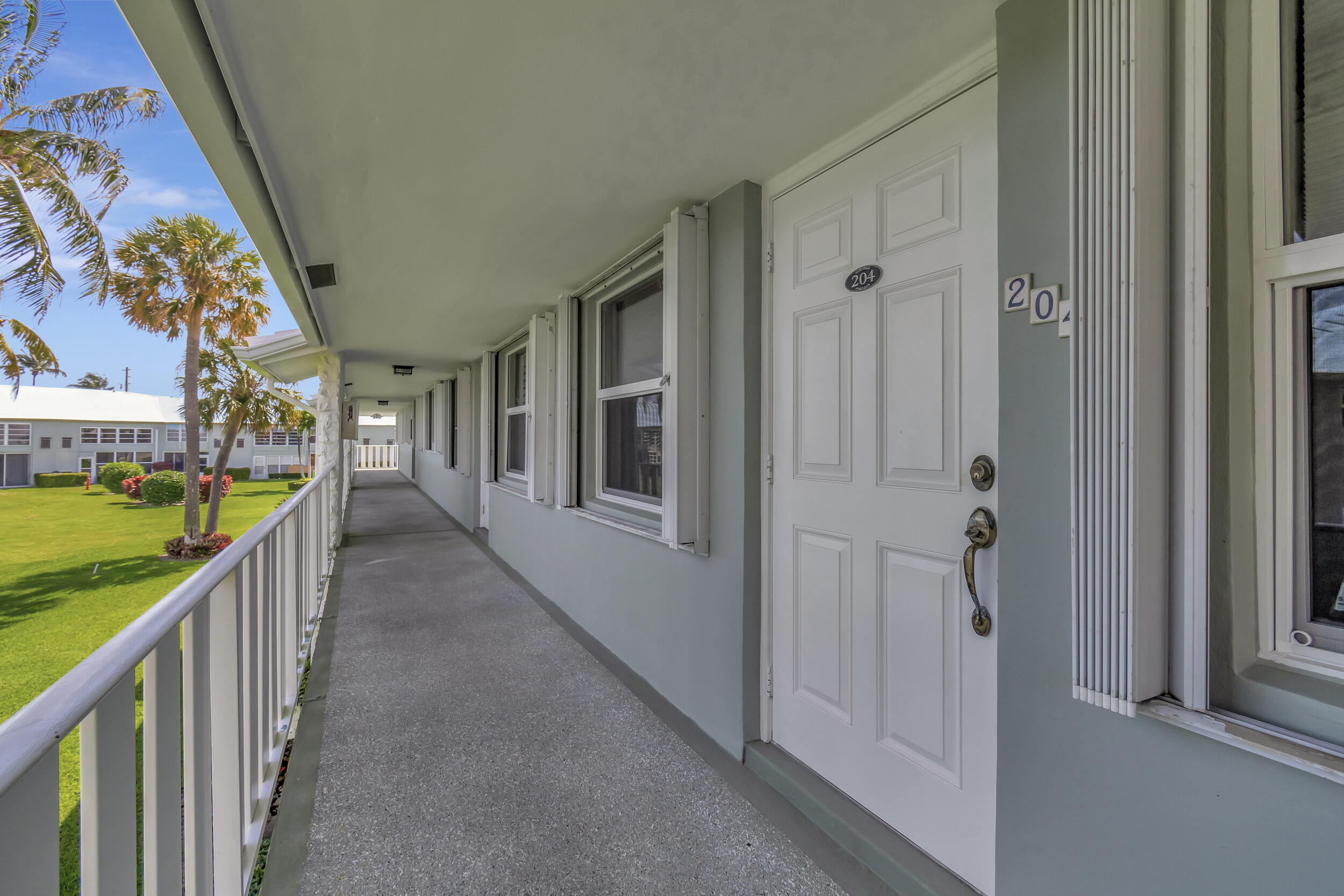 5540 North Ocean Boulevard, Unit 204 Ocean Ridge, FL 33435 - Photo 52 of 52 a view of a hallway with wooden floor and staircase