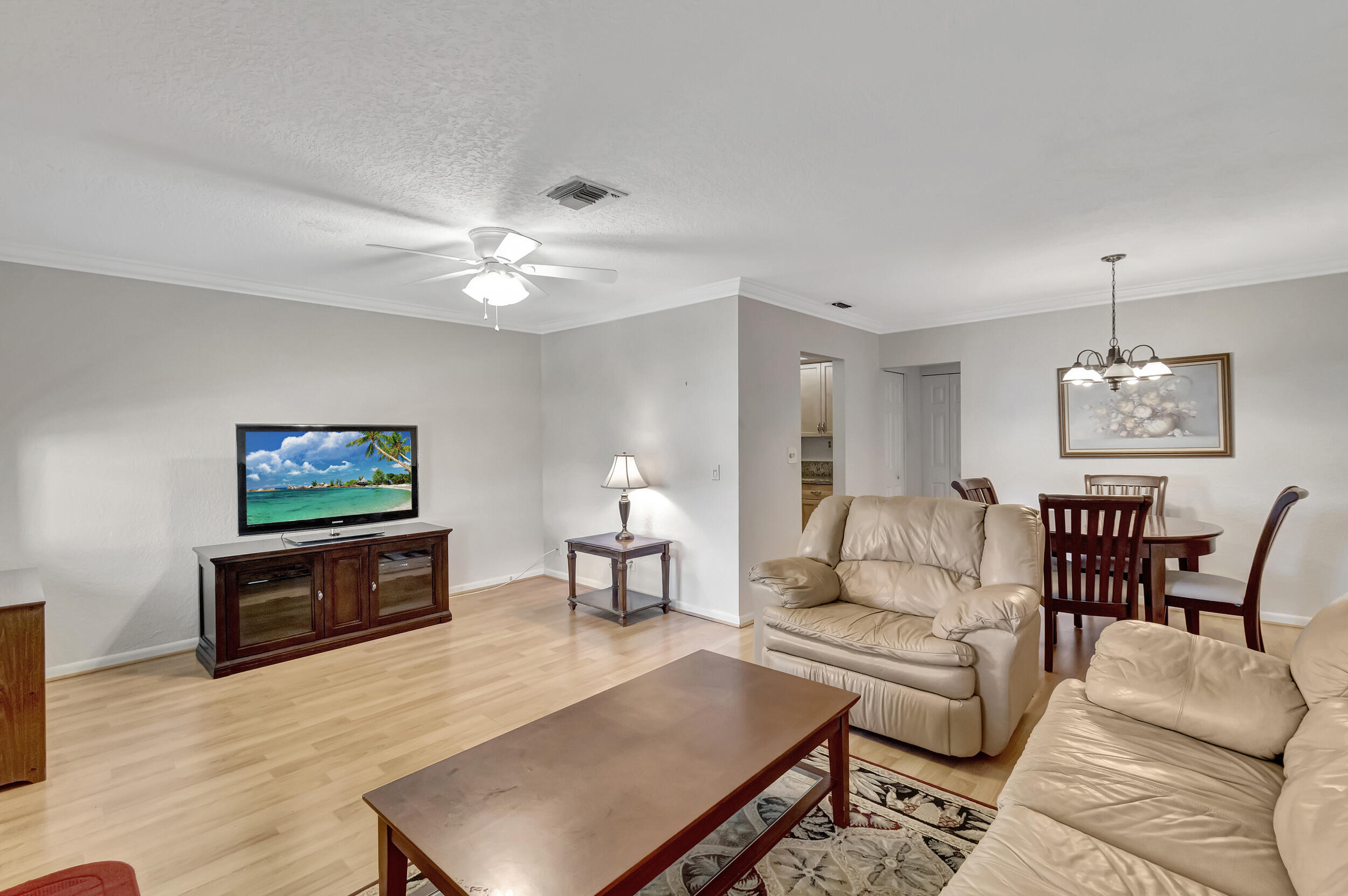 5540 North Ocean Boulevard, Unit 204 Ocean Ridge, FL 33435 - Photo 10 of 52 a living room with furniture a rug and a flat screen tv
