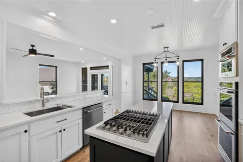 a kitchen with a sink stove and cabinets