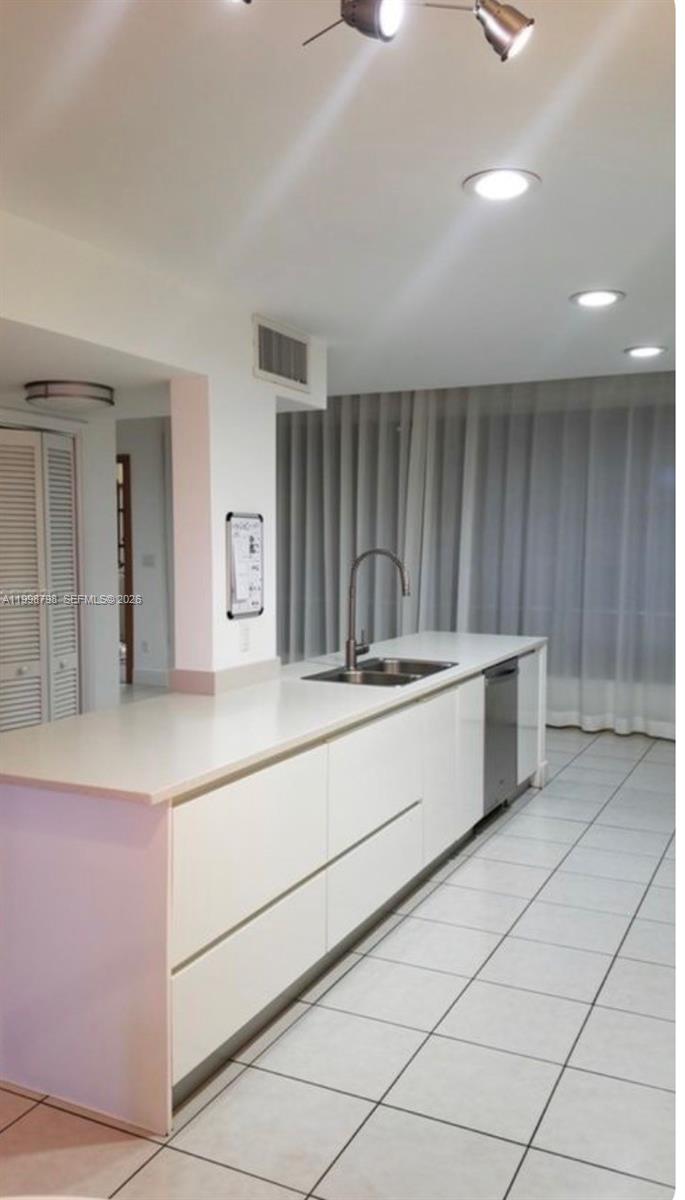3301 Raleigh Street, Unit 4A Hollywood, FL 33021 - Photo 2 of 11 a kitchen with stainless steel appliances kitchen island granite countertop a sink and cabinets