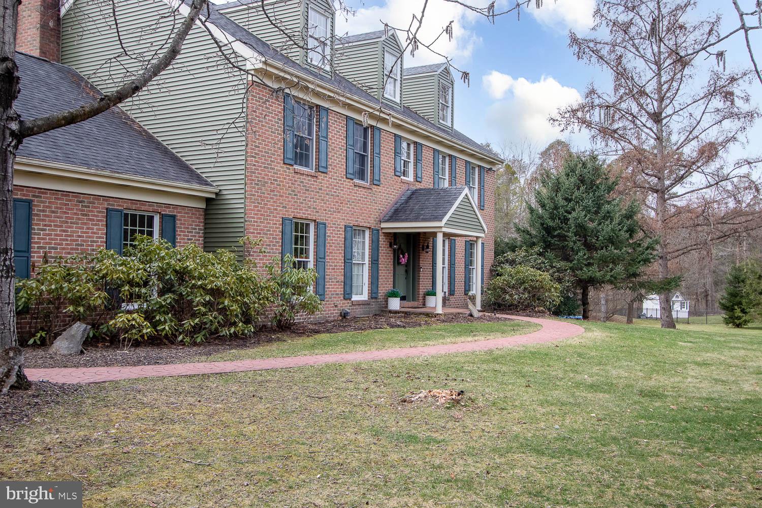 115 Heiskel Drive Port Matilda, PA 16870 - Photo 6 of 66 Charming brick home with lush greenery.