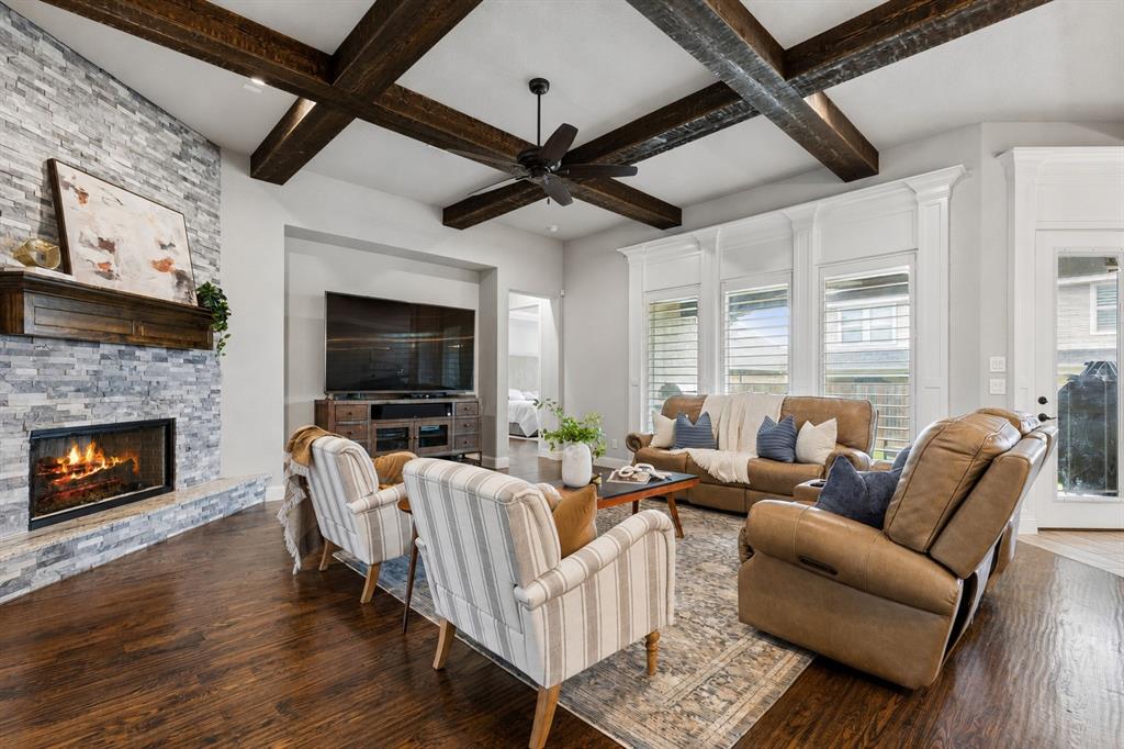 104 Ryder Court Hurst, TX 76053 - Photo 7 of 35 Soaring Open Living Space Featuring Stone Fireplace And Wood Beam Accents