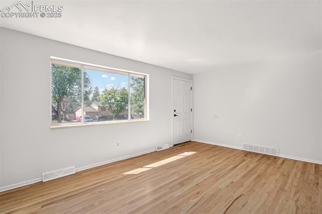 130 South Chelton Road Colorado Springs, CO 80910 - Photo 3 of 17 Living room with light wood-style floors
