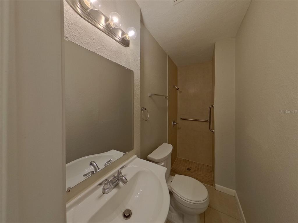 Undisclosed Address Clearwater, FL 33755 - Photo 14 of 22 a bathroom with a sink a toilet and shower