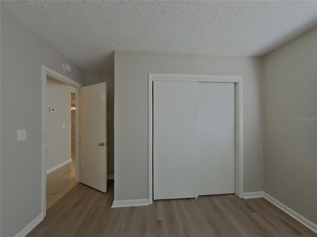 Undisclosed Address Clearwater, FL 33755 - Photo 16 of 22 an empty room with wooden floor