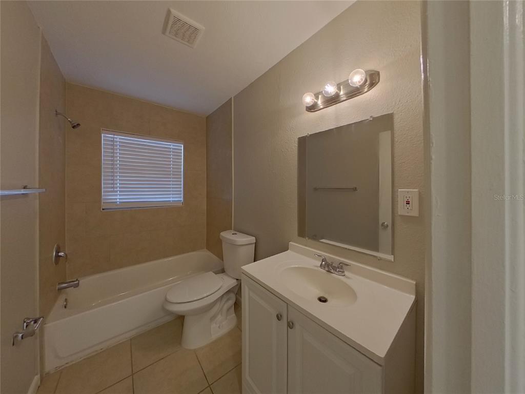 Undisclosed Address Clearwater, FL 33755 - Photo 20 of 22 a bathroom with a toilet a sink a mirror and a bathtub