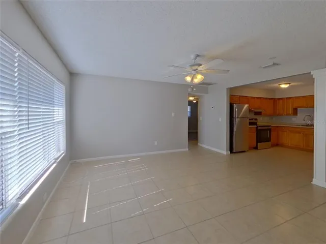 a view of a livingroom with a ceiling fan and window
