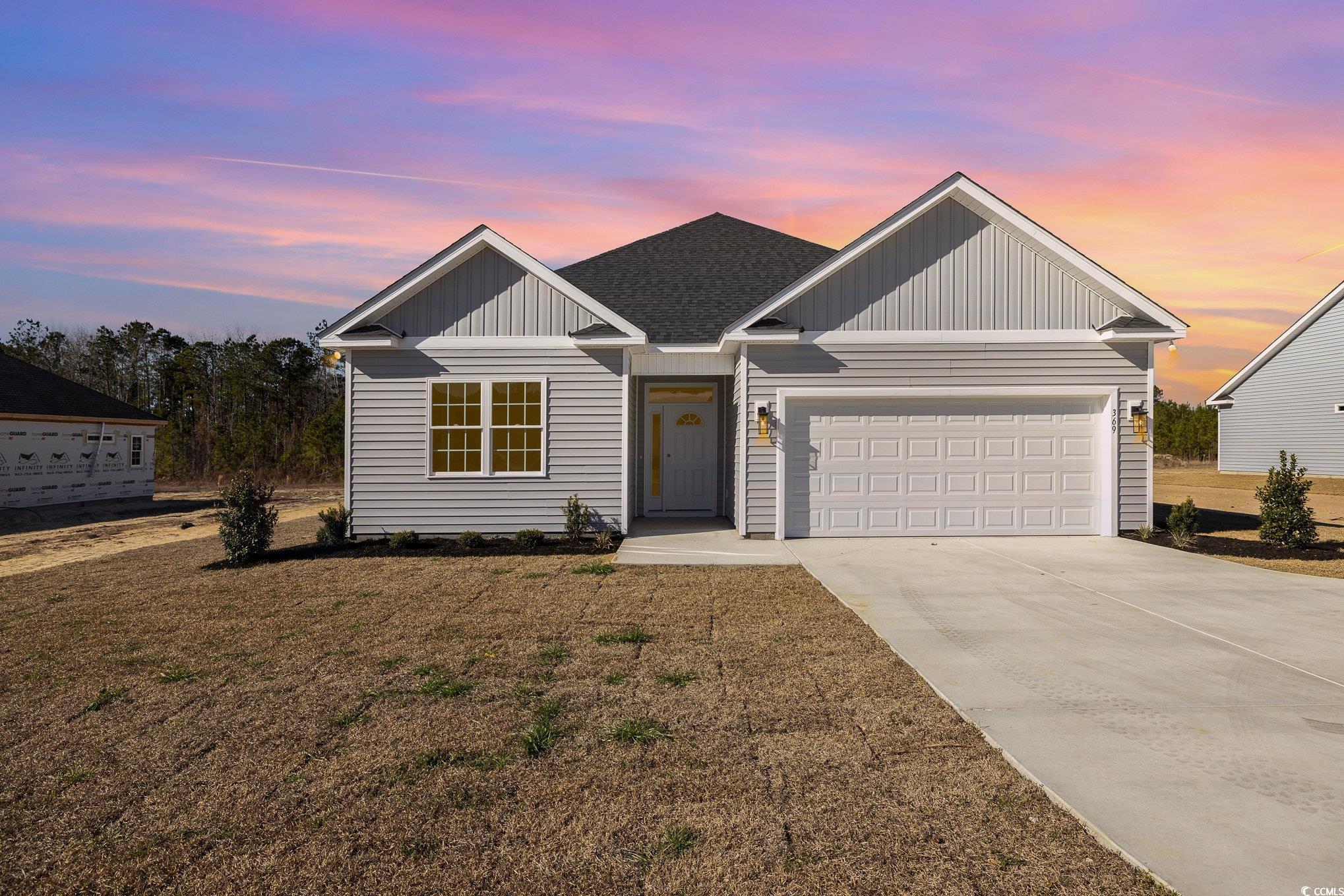 369 Log Cabin Road Loris, SC 29569 - Photo 1 of 30 View of front of property with a yard and a garage