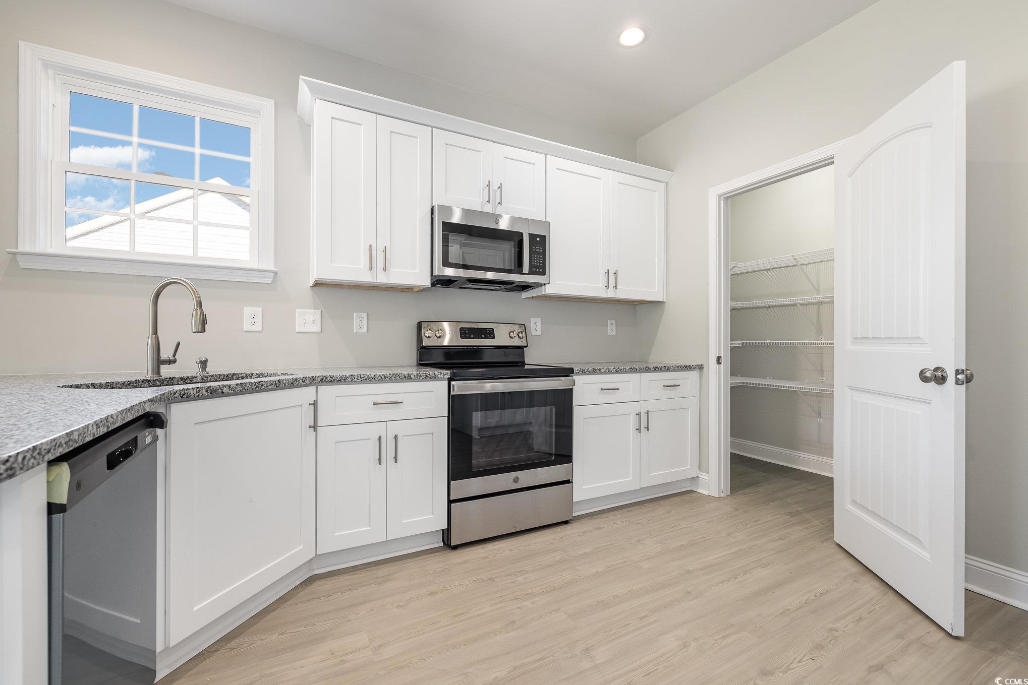 369 Log Cabin Road Loris, SC 29569 - Photo 13 of 30 Kitchen featuring sink, light hardwood / wood-styl