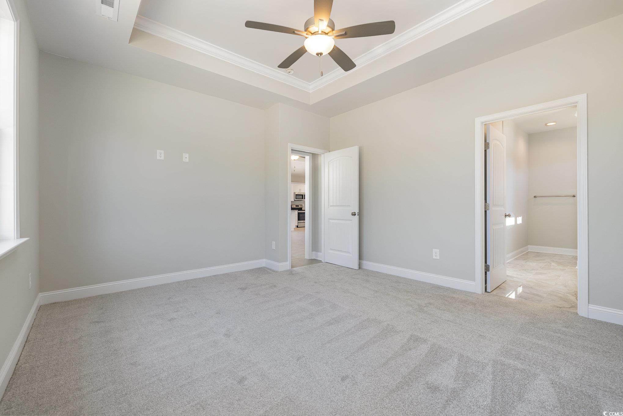 369 Log Cabin Road Loris, SC 29569 - Photo 17 of 30 Unfurnished bedroom featuring a tray ceiling, a wa