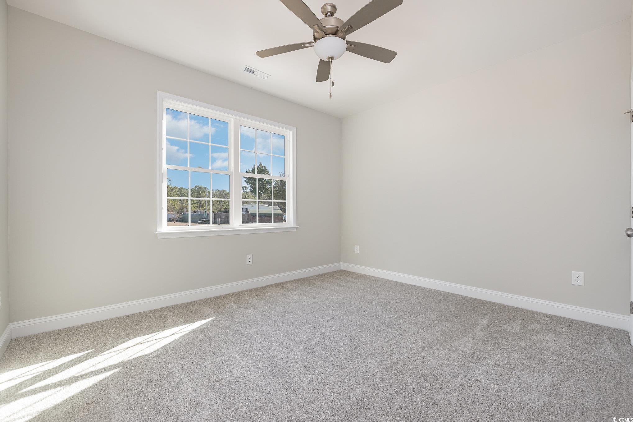 369 Log Cabin Road Loris, SC 29569 - Photo 21 of 30 Carpeted spare room featuring ceiling fan