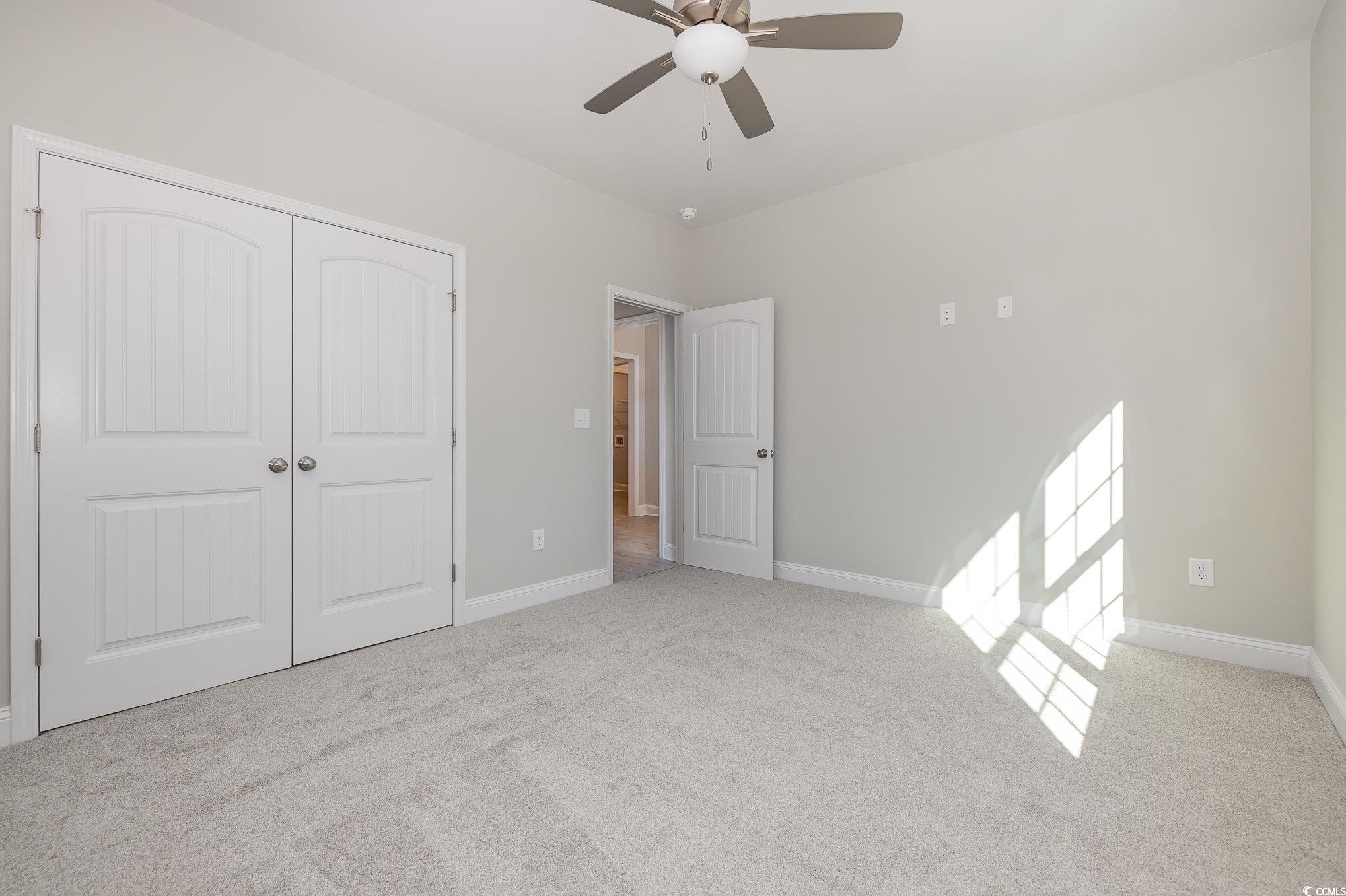 369 Log Cabin Road Loris, SC 29569 - Photo 22 of 30 Unfurnished bedroom with ceiling fan, a closet, an