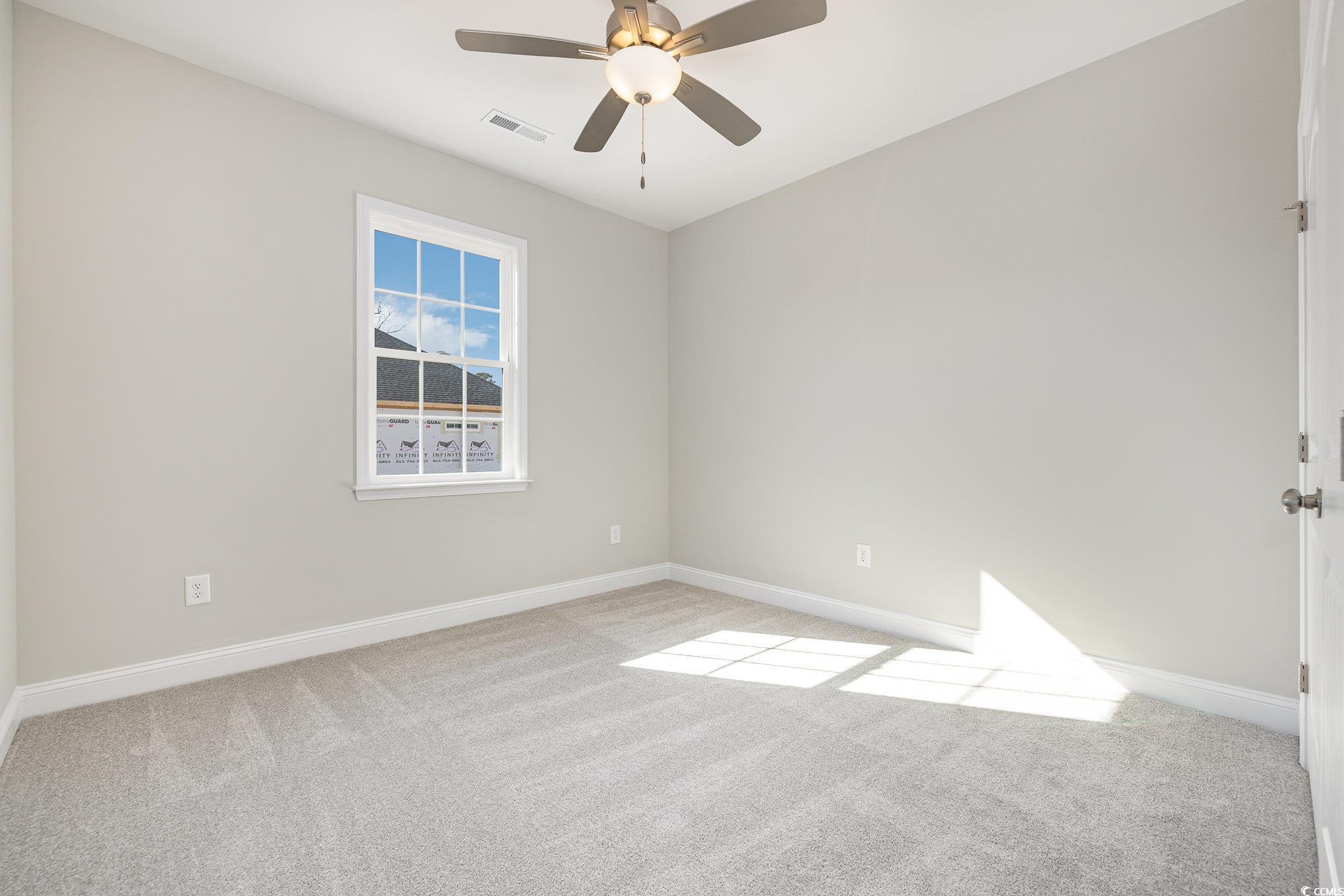 369 Log Cabin Road Loris, SC 29569 - Photo 23 of 30 Carpeted spare room with ceiling fan