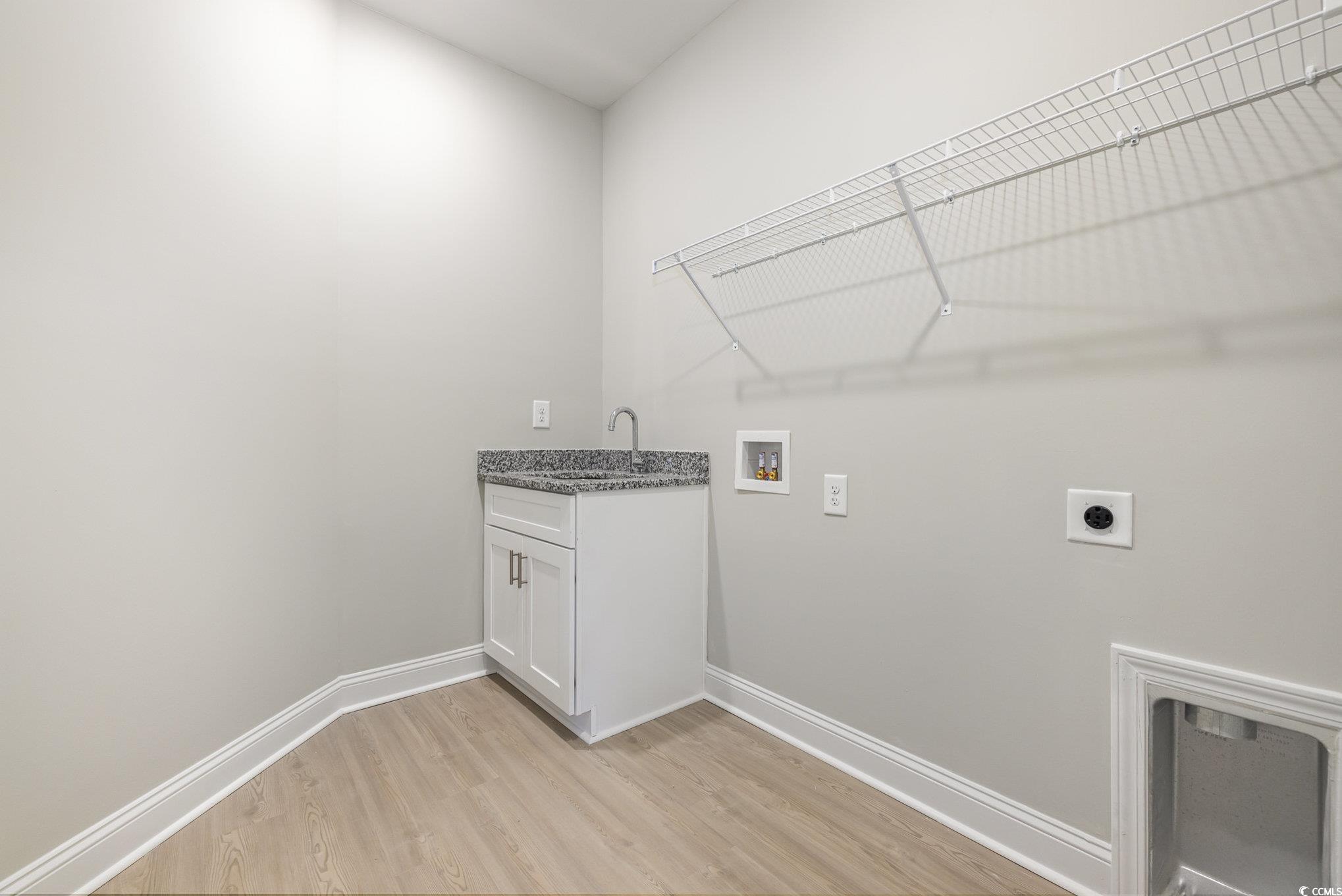 369 Log Cabin Road Loris, SC 29569 - Photo 26 of 30 Clothes washing area with cabinets, sink, hookup f
