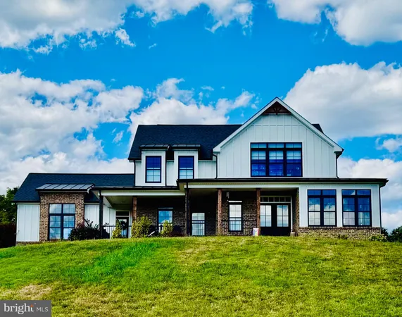 a view of a brick house with a big yard