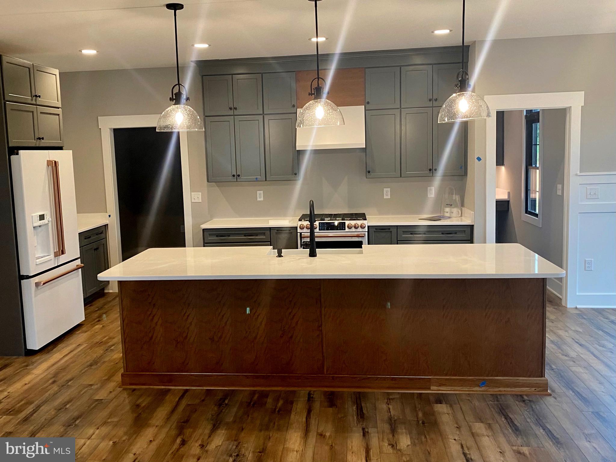 River Ridge Drive Middletown, VA 22645 - Photo 3 of 36 a kitchen with kitchen island a sink stainless steel appliances and wooden floor