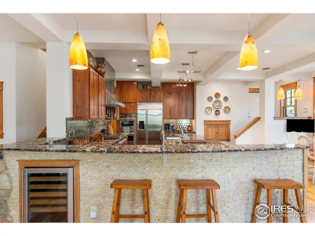 a kitchen with stainless steel appliances granite countertop a sink and cabinets