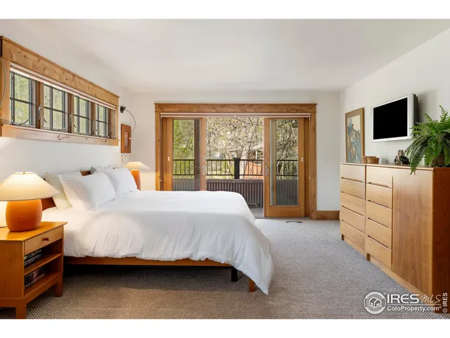 a bed room with furniture and a large window