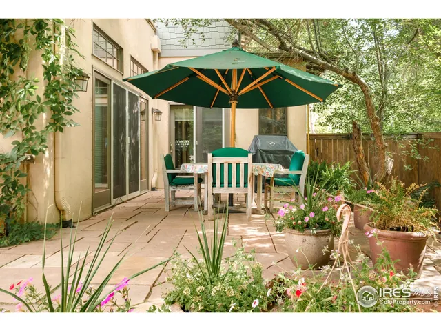 a building outdoor space with patio furniture and potted plants