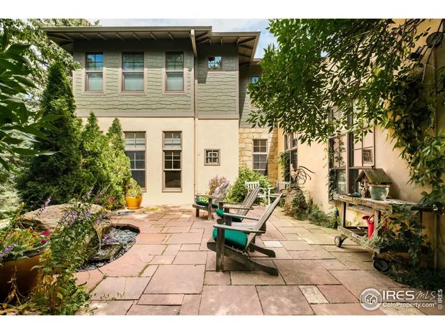 a front view of a building with a garden