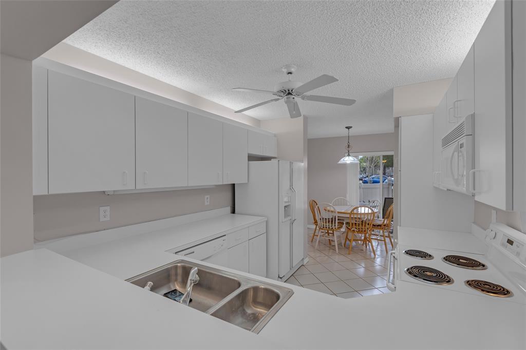 9599 Weldon Circle, Unit 103A Tamarac, FL 33321 - Photo 3 of 26 a room with gym equipment and wooden floor