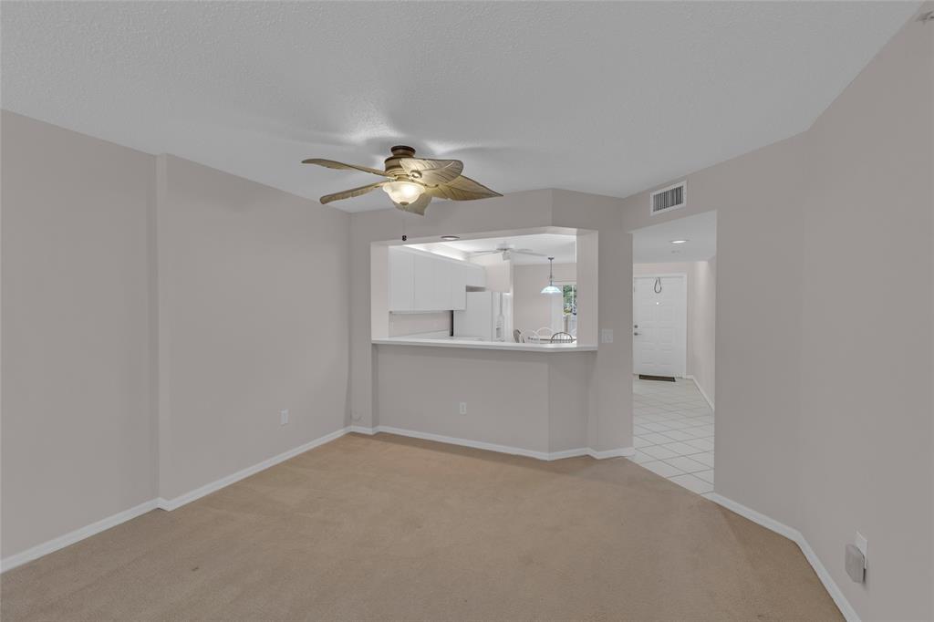 9599 Weldon Circle, Unit 103A Tamarac, FL 33321 - Photo 4 of 26 a view of empty room with wooden floor and ceiling fan