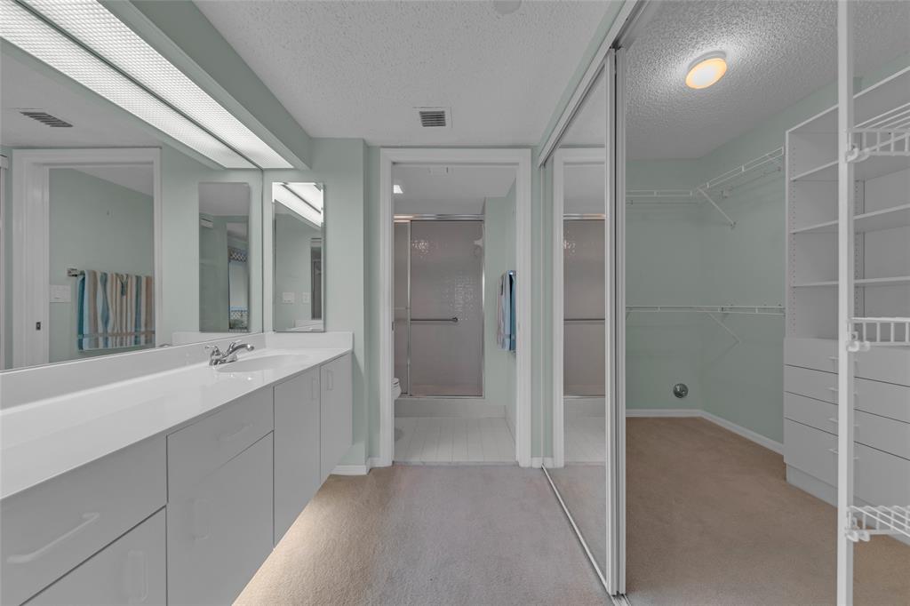 9599 Weldon Circle, Unit 103A Tamarac, FL 33321 - Photo 7 of 26 a bathroom with a double vanity sink and mirror