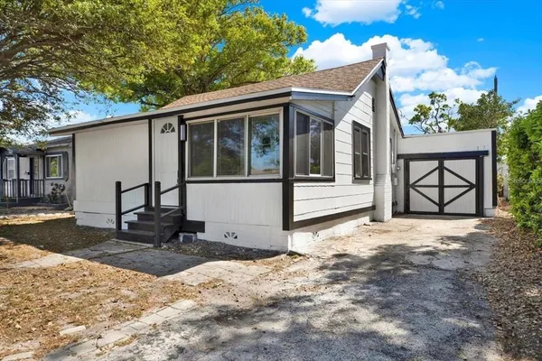 a view of a house with a yard and garage