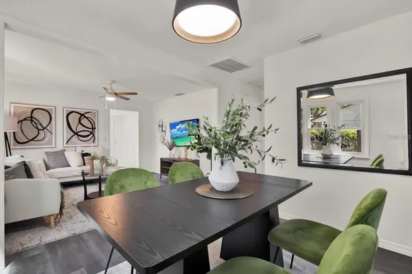 a view of a dining room with furniture and chandelier