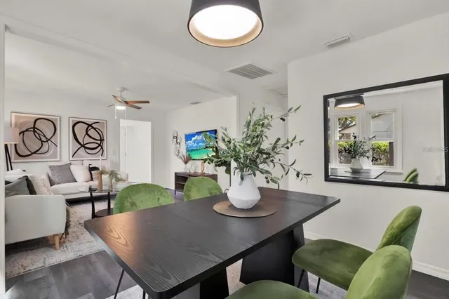 a view of a dining room with furniture and chandelier