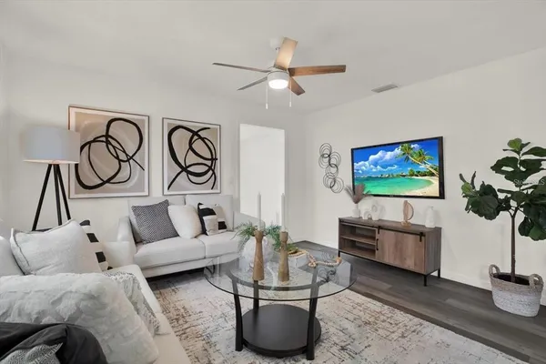 a living room with furniture and a flat screen tv