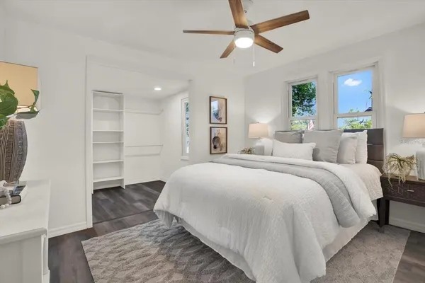 a spacious bedroom with a bed and a chandelier
