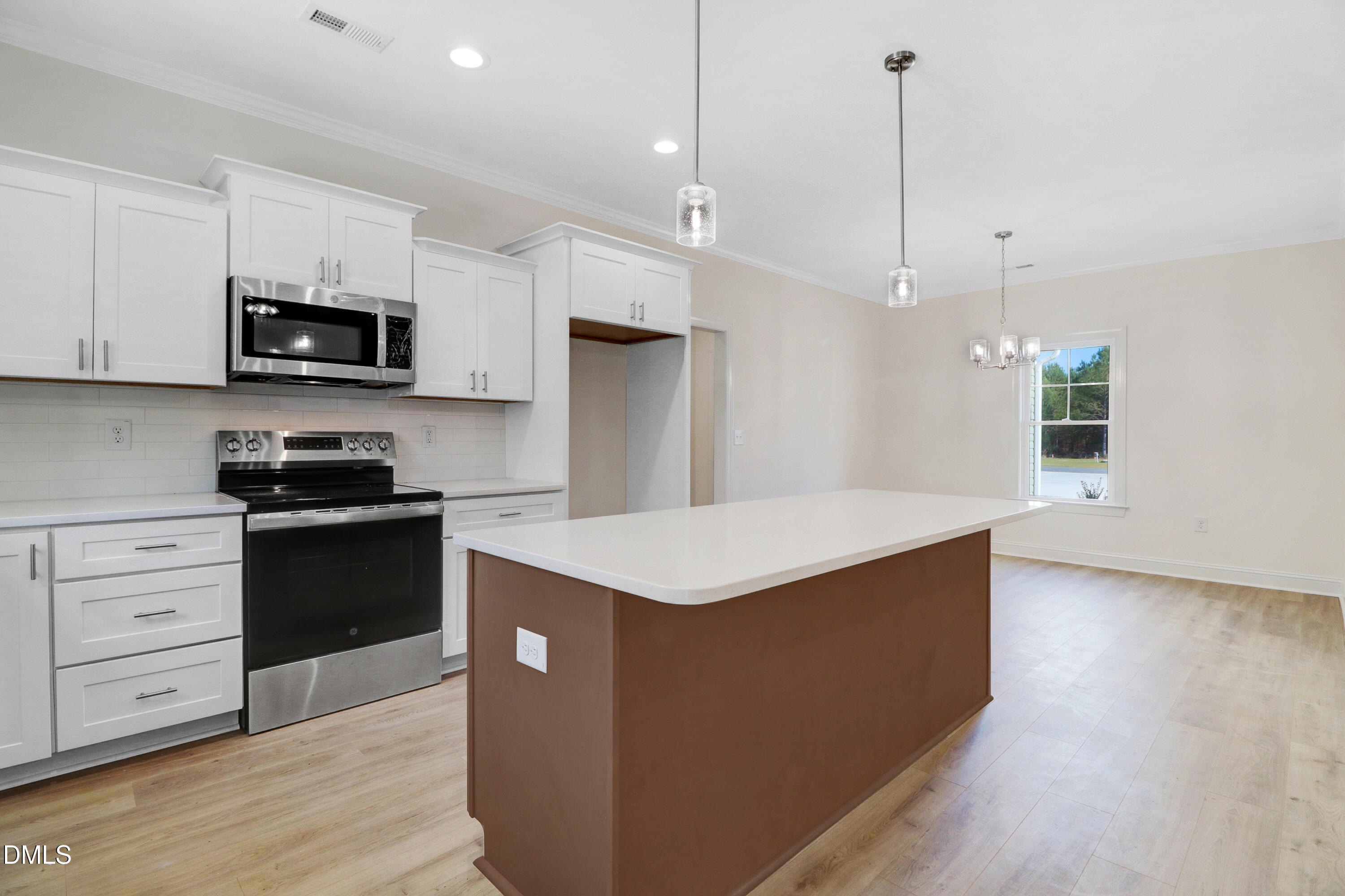 110 Rae Drive Pikeville, NC 27863 - Photo 12 of 35 a kitchen with stainless steel appliances kitchen island granite countertop a stove a sink and a wooden floor
