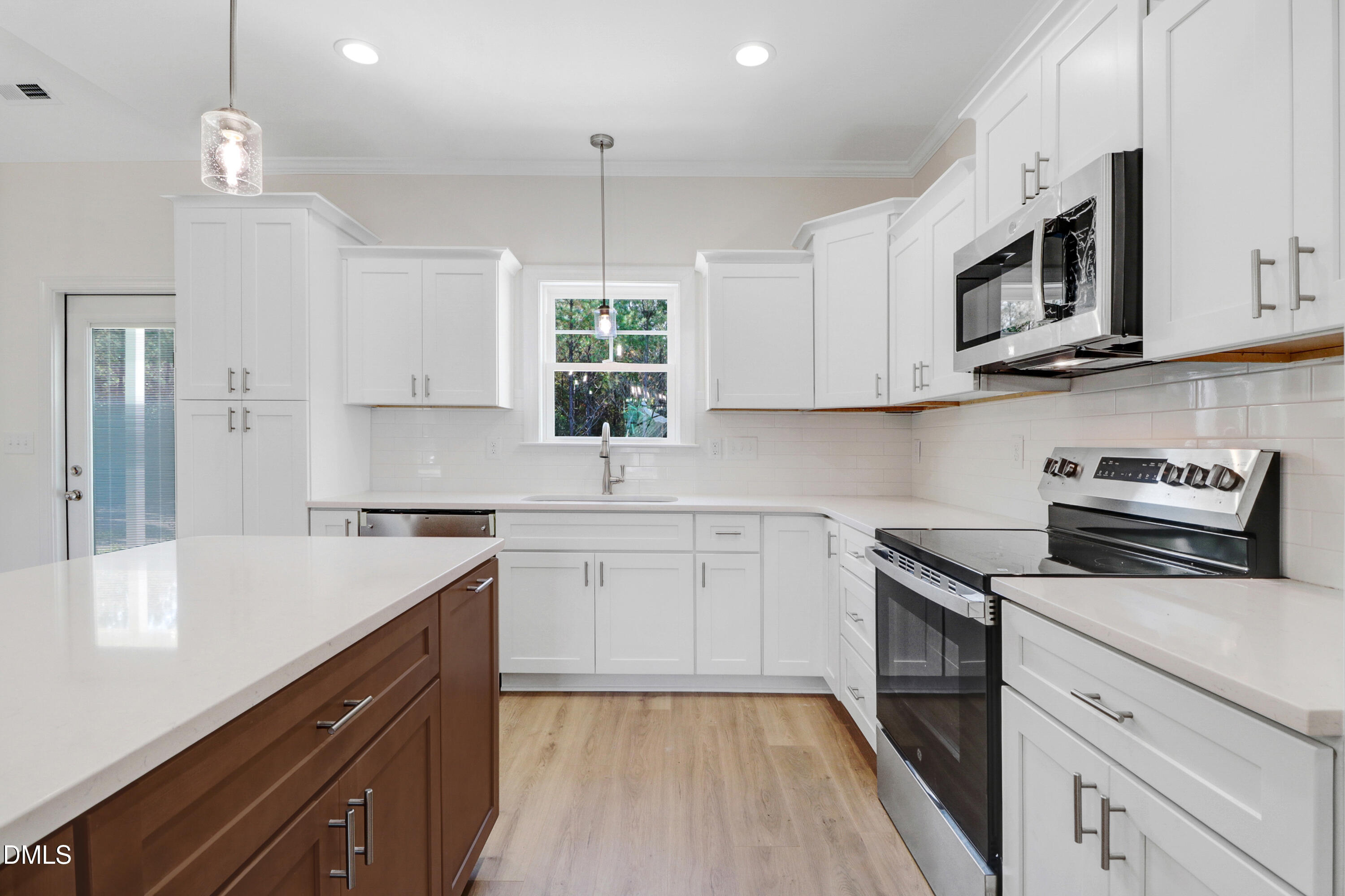 110 Rae Drive Pikeville, NC 27863 - Photo 15 of 35 a kitchen with stainless steel appliances granite countertop a sink a stove a microwave and cabinets