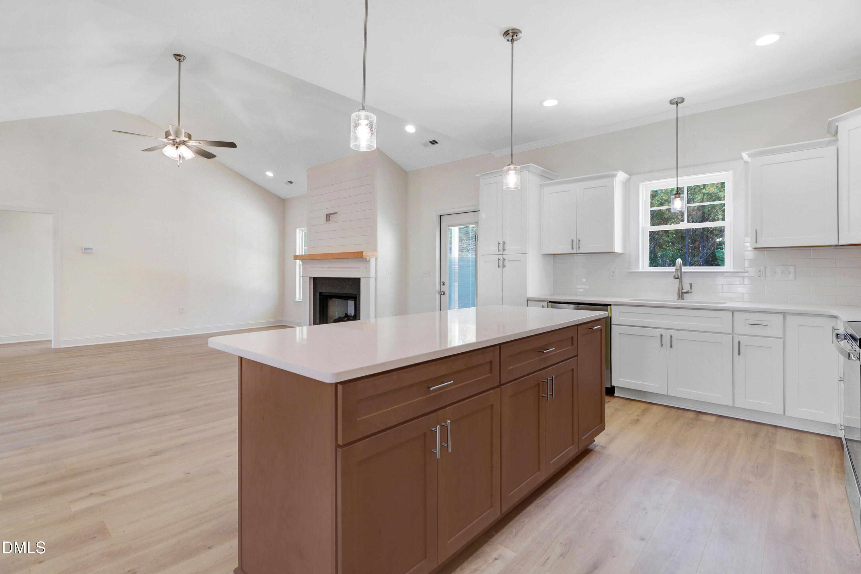 110 Rae Drive Pikeville, NC 27863 - Photo 16 of 35 a kitchen with a stove kitchen island and a wooden floor