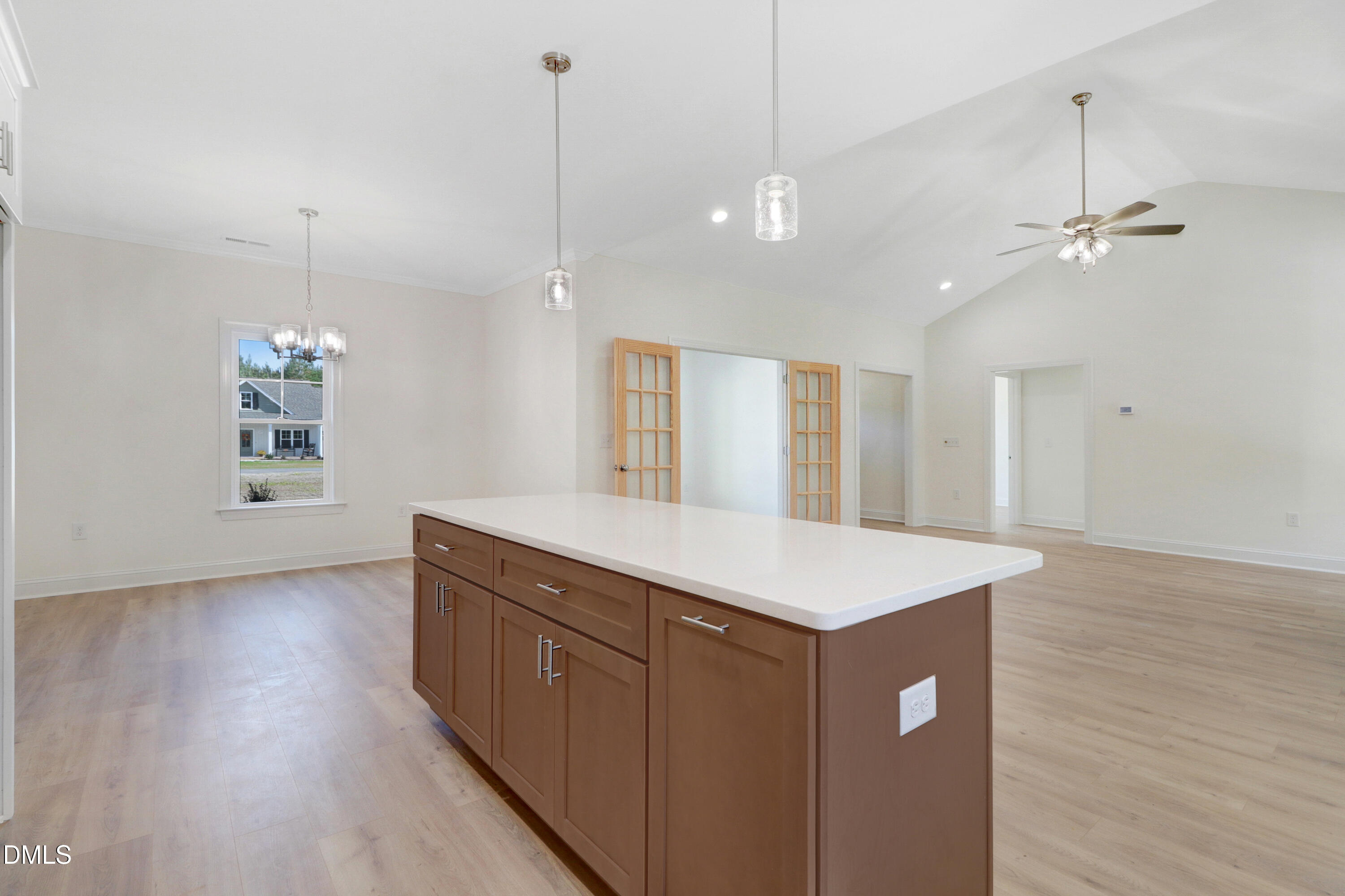 110 Rae Drive Pikeville, NC 27863 - Photo 17 of 35 a view of a kitchen island a sink wooden floor and a ceiling fan